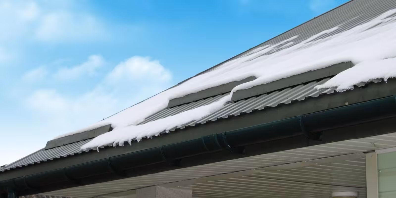 inspector checking metal roof for rust and loose fasteners